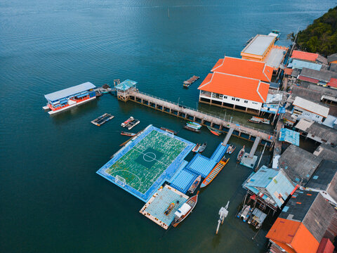Floating soccer field in village on water in Thailand 