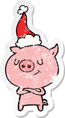 happy distressed sticker cartoon of a pig wearing santa hat