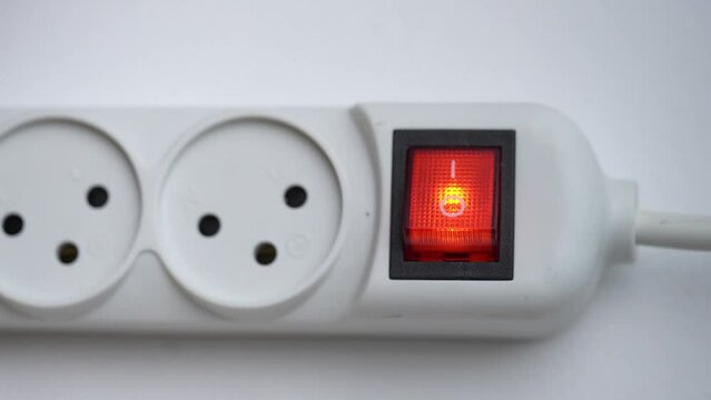 Hand of a person turning on and off a power spitter