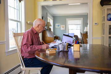 Senior Man at Home Paying bills personal finance 