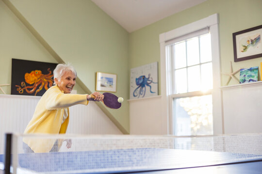 Competitive Senior Citizen lifestyle woman playing ping pong match