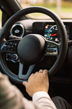 Close-Up Of A Male Hand On a Steering Wheel