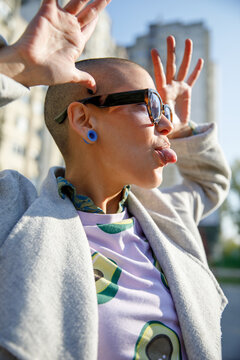 Crazy woman in sunglasses teasing making funny face on a sunny day