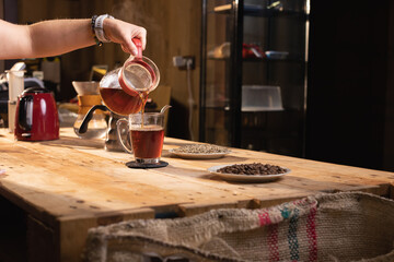 Professional barista preparing coffee. Young woman making coffee. Alternative ways of brewing coffee. Coffee shop concept