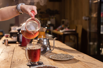 Professional barista preparing coffee. Young woman making coffee. Alternative ways of brewing coffee. Coffee shop concept