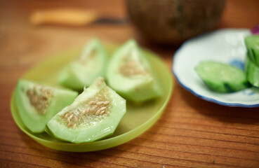 Compote of sliced honeydew melon on table closeup
