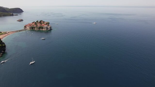 Aerial video of Sveti Stefan Montenegro Old city beach. Beautiful place, old island, Montenegro  tourism.
