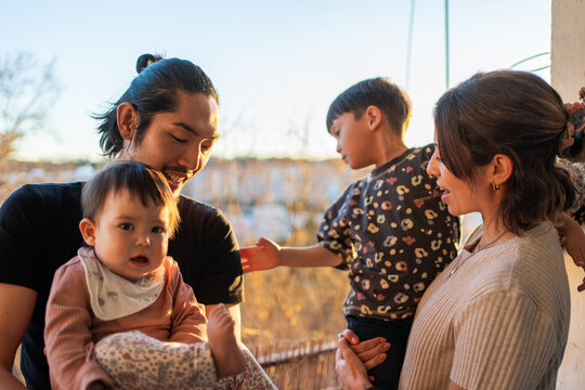 Family Enjoying Time Together Outdoors At Sunset.