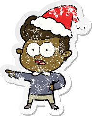 distressed sticker cartoon of a staring man wearing santa hat
