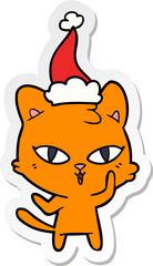 sticker cartoon of a cat wearing santa hat