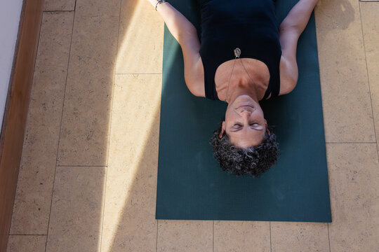 Shavasana yoga pose on mat.