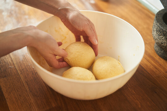 Housewife kneading dough in a kitchen