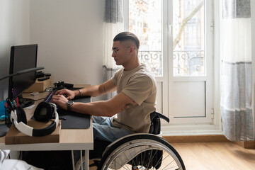 Young Adult Wheelchair User Using A Desktop Computer