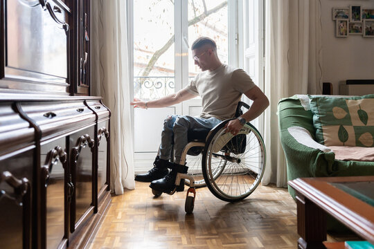 Young Man With A Disability Reading A Book