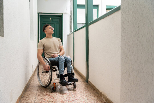 Wheelchair User Goes Through A Hall Of A Building