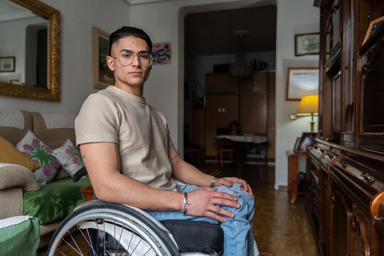 Portrait Of Young Man With A Disability At Home Looking At Camera.