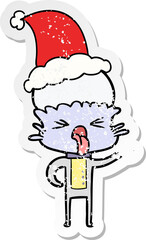 disgusted distressed sticker cartoon of a alien wearing santa hat