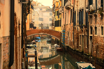 venice street with water during the golden hour
