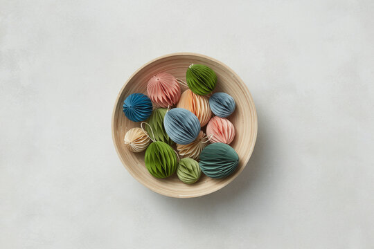 Crafted paper Easter eggs in bamboo bowl.