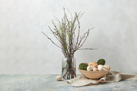Willow branches with moss and wooden Easter eggs.