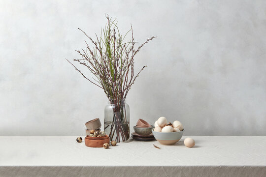 Willow branches with wooden eggs and porcelain.