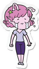 sticker of a cartoon crying alien girl