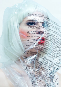 futuristic android beautiful blonde doll in plastic wrap packaging