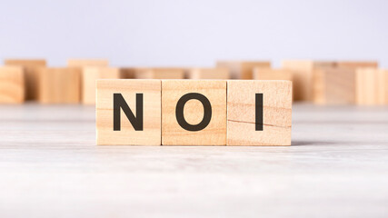 NOI - word concept written on wooden cubes or blocks on a light background