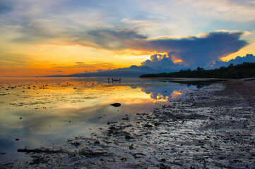 Fisherman in sunset in the island of Siquijor in Philipines. Siquijor island in Filipines- Sunset light in linely island.  Filipinas landscape with golden light. Golden hour. 