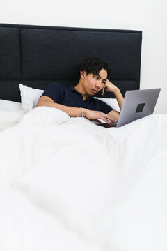 Young man laying on bed