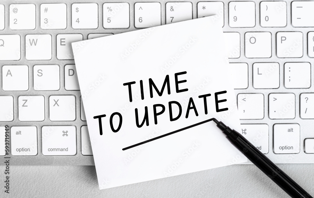 Poster white paper with text update lying on the keyboard