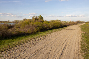 Fototapeta na wymiar Beautiful nature dirt road with grass and sunny day with blue sky