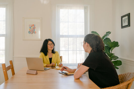 woman listening during an interview with a young woman 