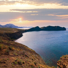 Summer rocky coastline  ( Chameleon Cape on horizon, Crimea, Ukraine ).