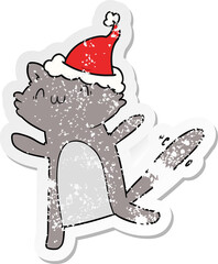 distressed sticker cartoon of a dancing cat wearing santa hat