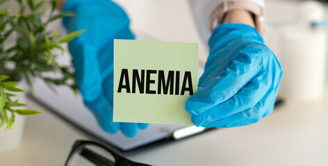 Anemia text on paper in doctor hands, medical concept.