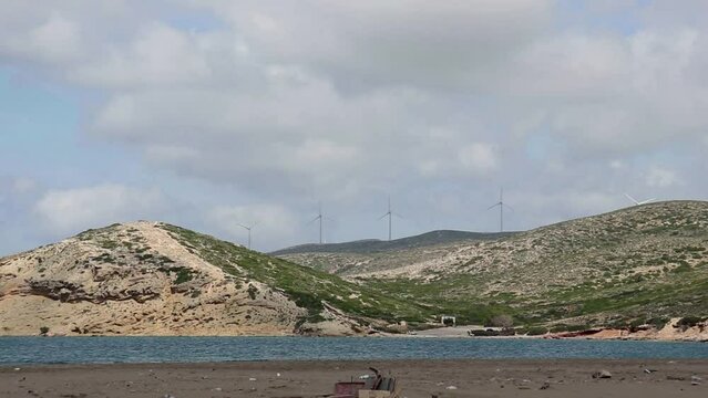 Wind mills spinning view of Prasonisi Beach, Greece, a meeting spot between the Mediterranean sea and the Aegean sea