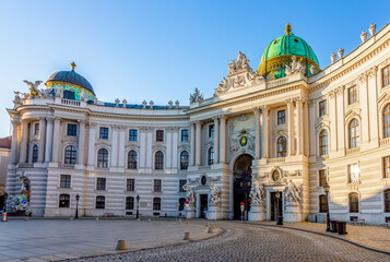 Fototapeta na wymiar Hofburg palace on St. Michael square (Michaelerplatz) at sunrise, Vienna, Austria