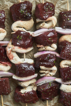 Skewers of raw beef and mushroom chunks