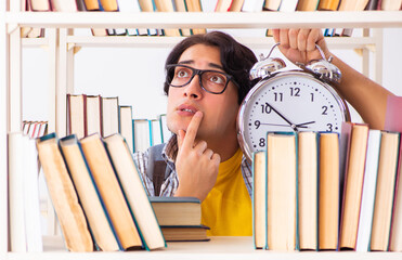 Male student preparing for exams at library