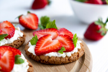 Homemade strawberry tart with oat biscuit and whipped cream. Recipe of fast berry cake for breakfast or holiday. Summer light dessert.