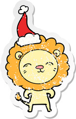 distressed sticker cartoon of a lion wearing santa hat