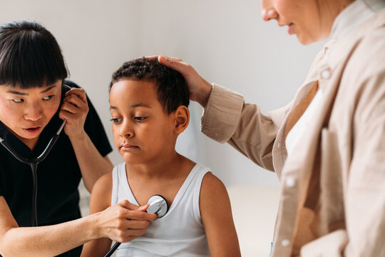 Sick Boy with His Mother at Doctor's Checkup