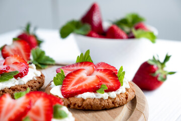 Homemade strawberry tart with oat biscuit and whipped cream. Recipe of simple berry cake for breakfast or holiday. Summer light dessert.