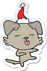 sticker cartoon of a dog dancing wearing santa hat