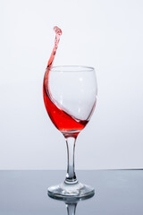 Beautiful splash of red wine in a glass