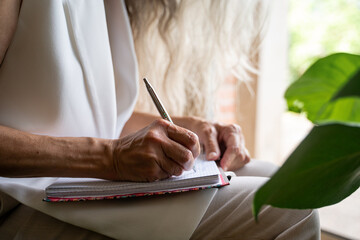 mature woman writing close-up