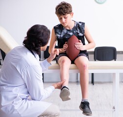 Boy american football player visiting young doctor traumatologis
