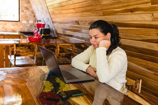 Woman sitting at a table with a computer