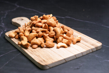  cashew nuts on a chopping board on table 